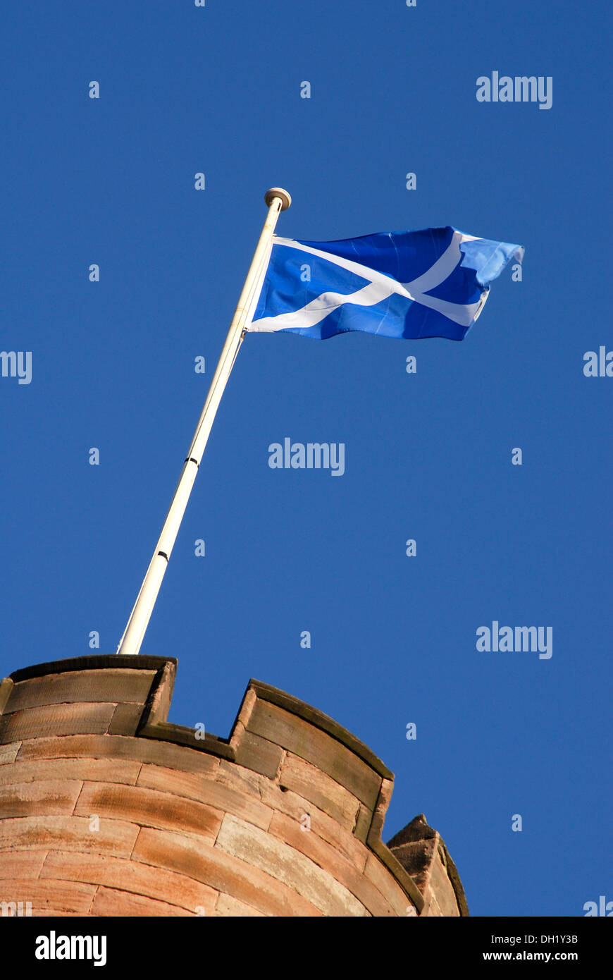The National flag of Scotland, also known as the Saltire or St Andrews Cross flying from a turret at Dalhousie Castle,Midlothian Stock Photo