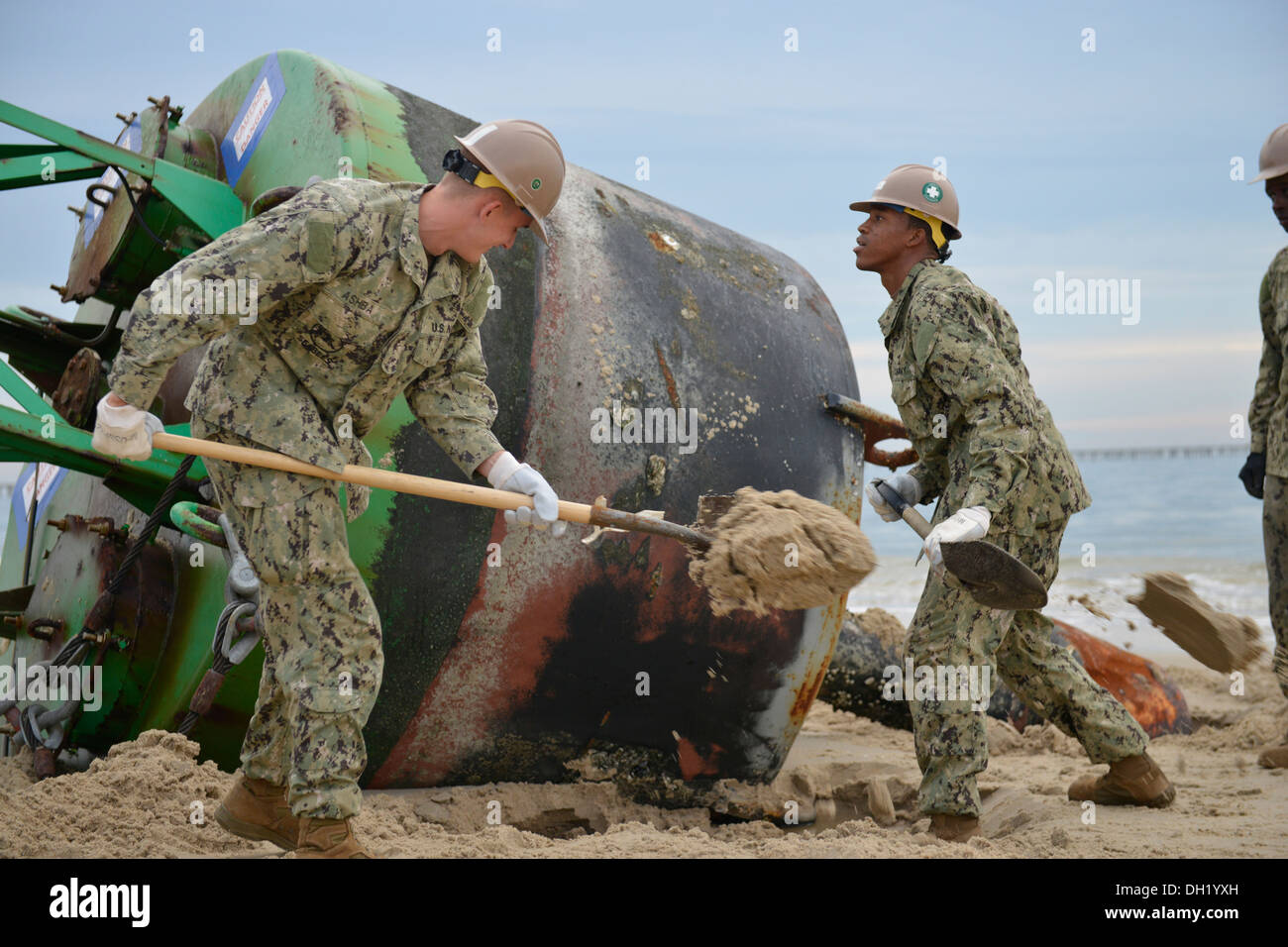 Navy sailors from Amphibious Construction Battalion 2, Beachmaster Unit 2, and Naval Beach Group 2 out of Joint Expeditionary Base Little Creek work with the Coast Guard to remove two washed-ashore buoys from Chic's Beach and Oceanview areas of Virginia B Stock Photo