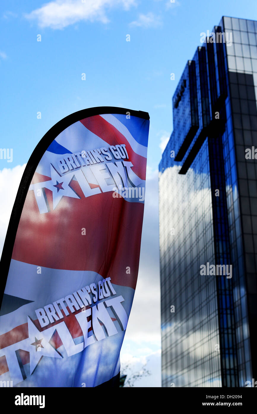 Britain's Got Talent banner against a city sky scraper tower block and a blue sky - upright image - portrait Stock Photo