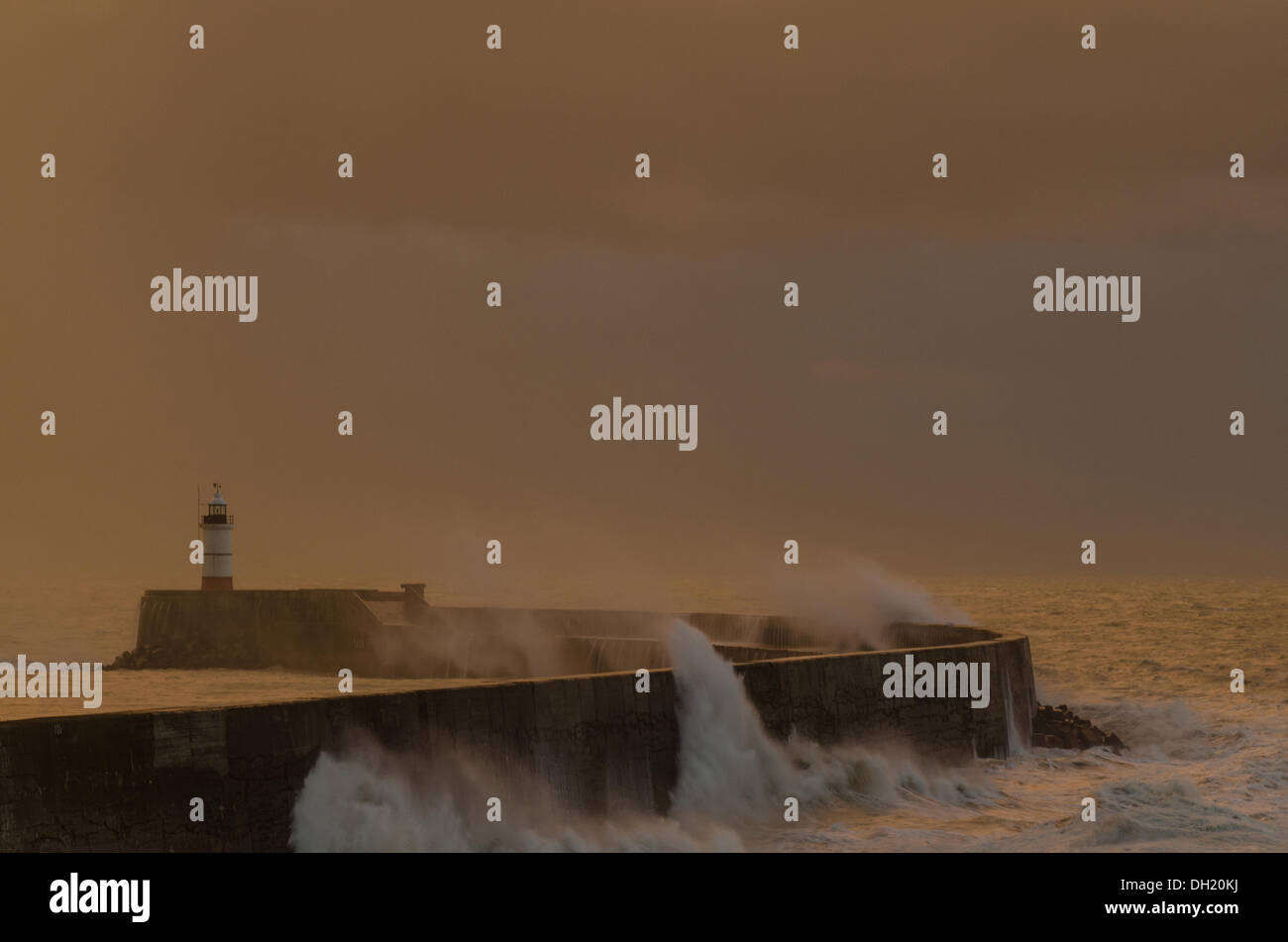 Newhaven, East Sussex, UK. 28th October 2013. Waves crashing at Newhaven, East Sussex during the St Jude storm just as the sun was setting. © mark upfield / Alamy Live News. Stock Photo