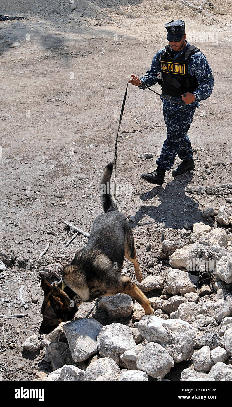 Master-at-Arms 2nd Class Michael Probus, from Rahway, N.J., follows military working dog Karo in a search for hidden training aids at Naval Air Station (NAS) Key West. NAS Key West is a state-of-the-art training facility for air-to-air combat fighter airc Stock Photo