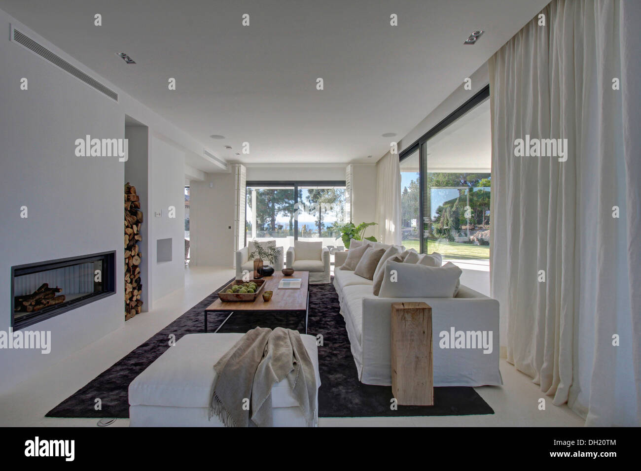 White Drapes On Large Windows In Modern White Living Room With