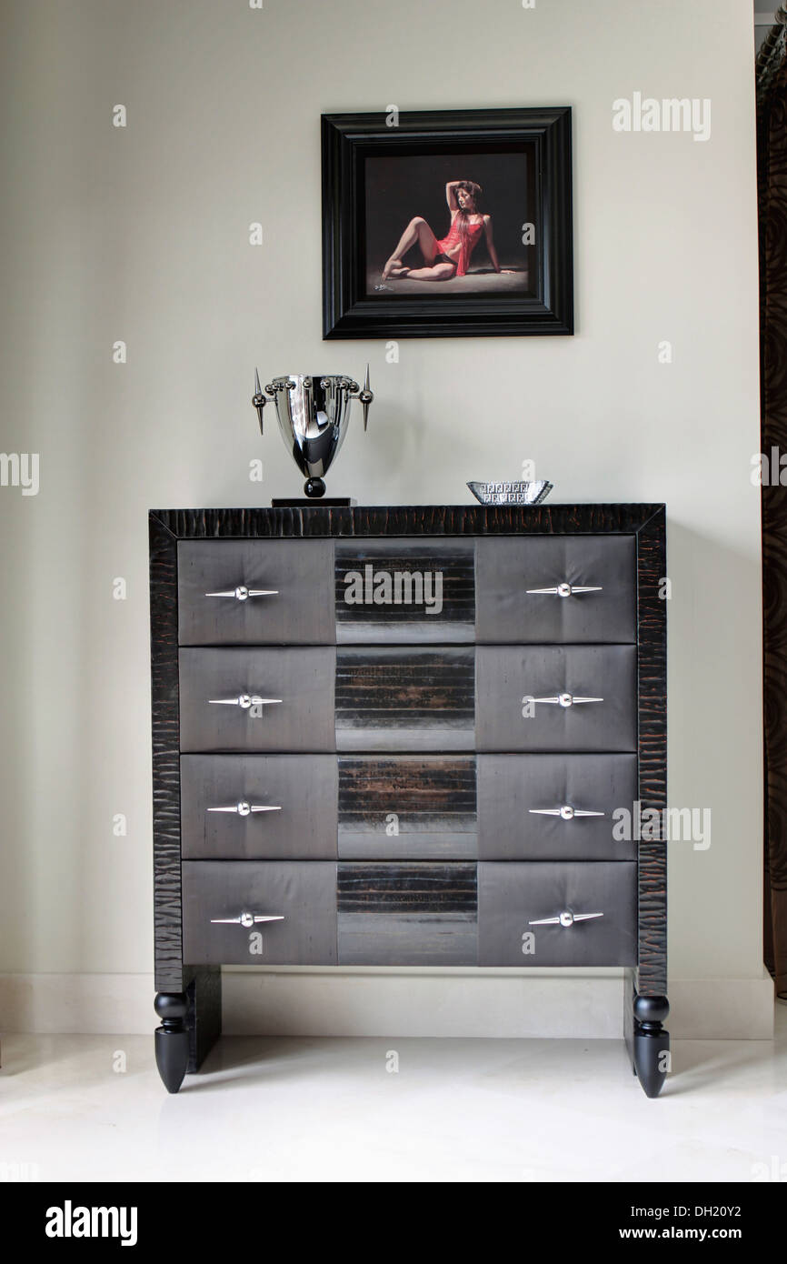 Painting Of A Woman Above Unusual Textured Metal Chest Of Drawers