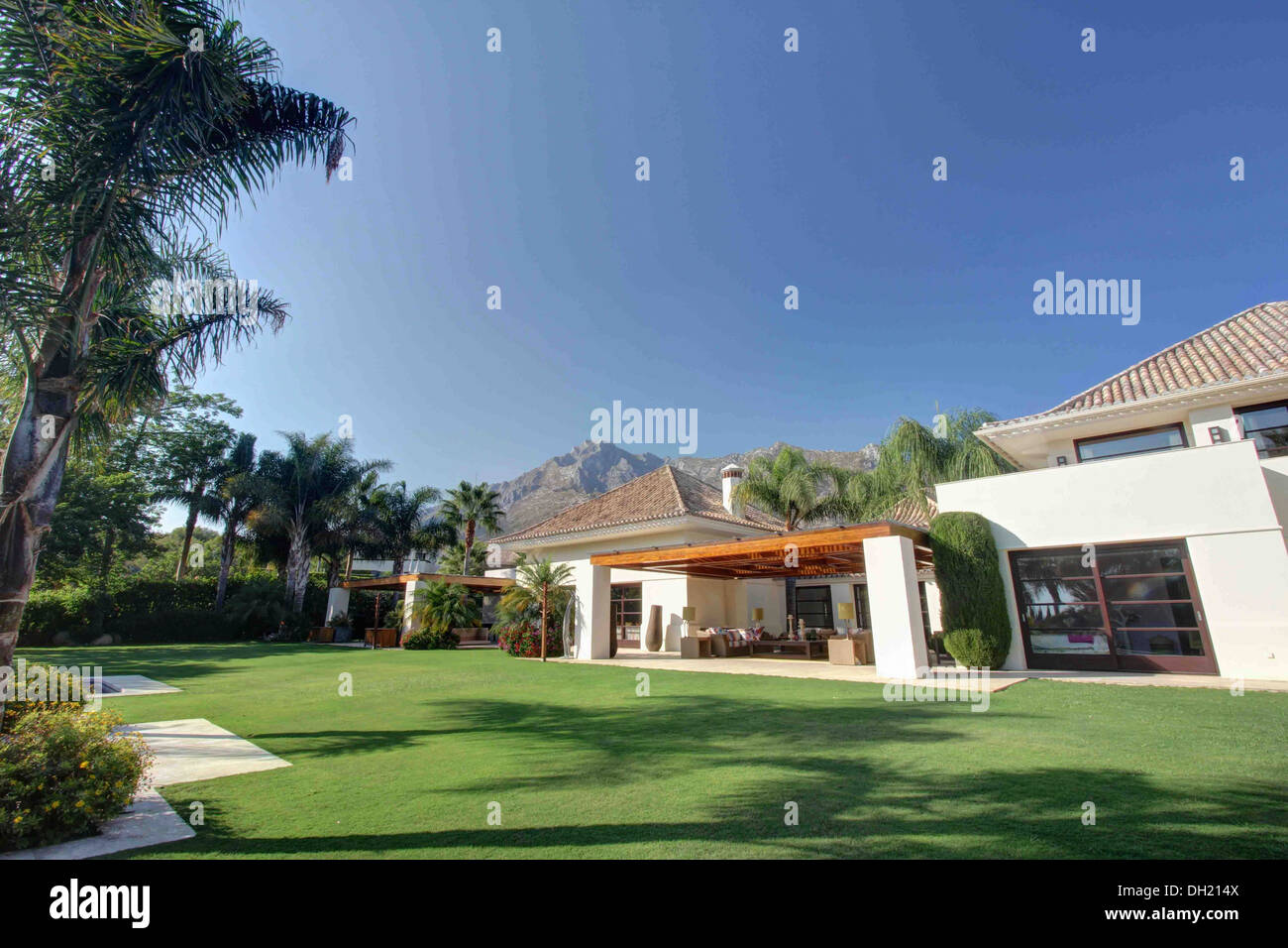Lush green lawn in grounds of large modern villa in southern Spain ...