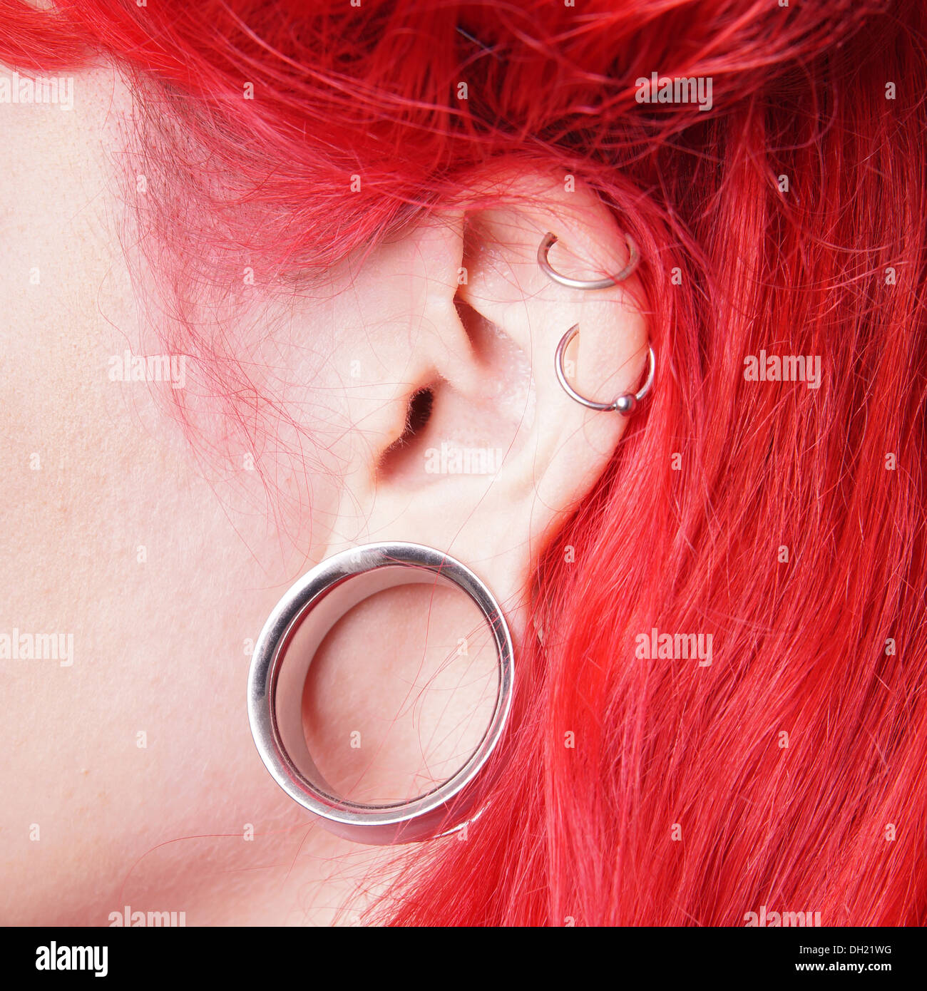 stretched ear lobe piercing with flesh tunnel Stock Photo Alamy