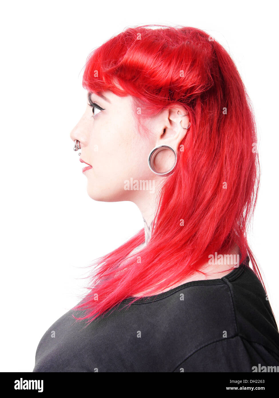 young woman with facial piercings and tattoos Stock Photo