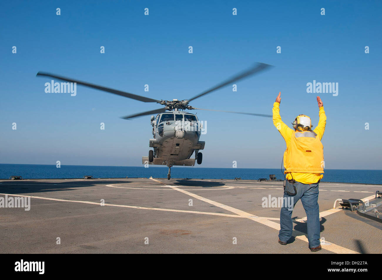 An MH-60 Seahawk helicopter assigned to the Dragon Whales of Helicopter Sea Combat Squadron (HSC) 28 conducts flight operations Stock Photo