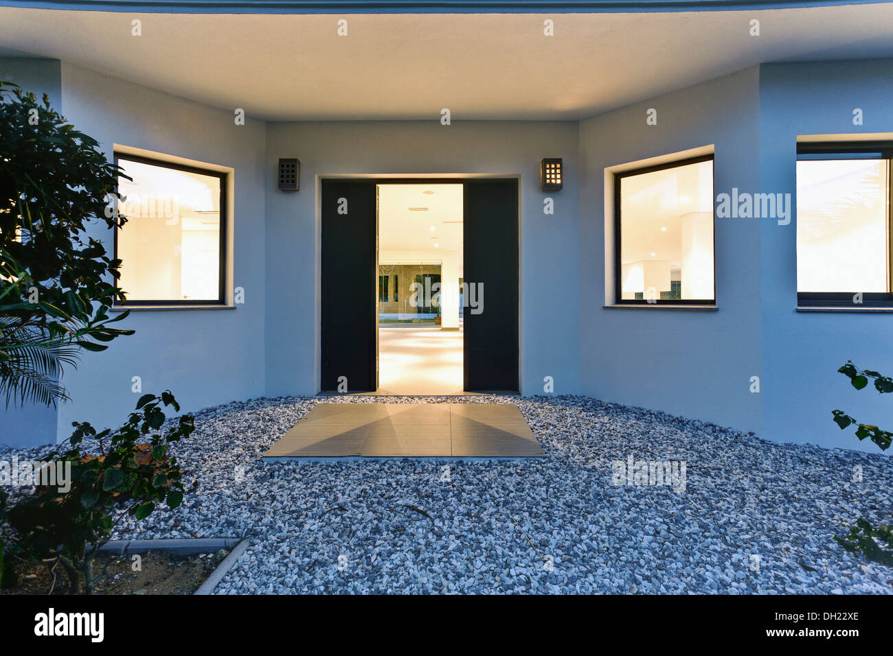 Metal paving slab on gravel in front of door to large, empty, newly built villa in Spain Stock Photo