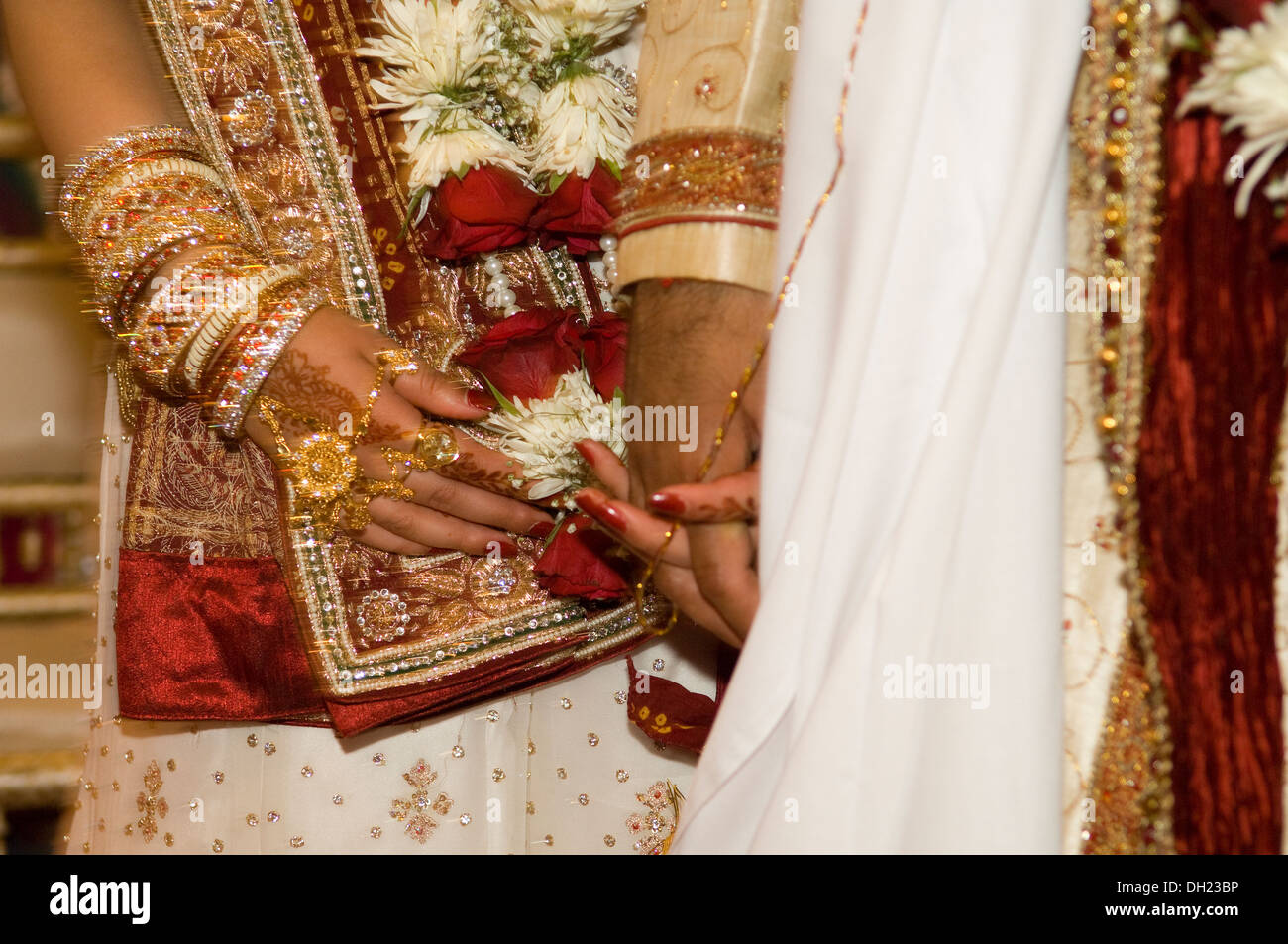 Bride and Groom dressed in all their finery celebrating their Traditional Hindu wedding Stock