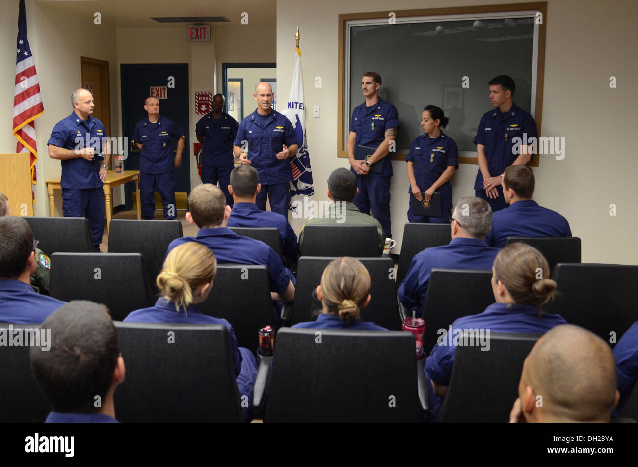 Rear Adm. Charles Ray, Coast Guard Pacific Area deputy commander, speaks to Air Station San Francisco personnel after presenting three of their own with Coast Guard Achievement Medals during an All Hands held at the air station Friday, Oct. 25, 2013. The Stock Photo