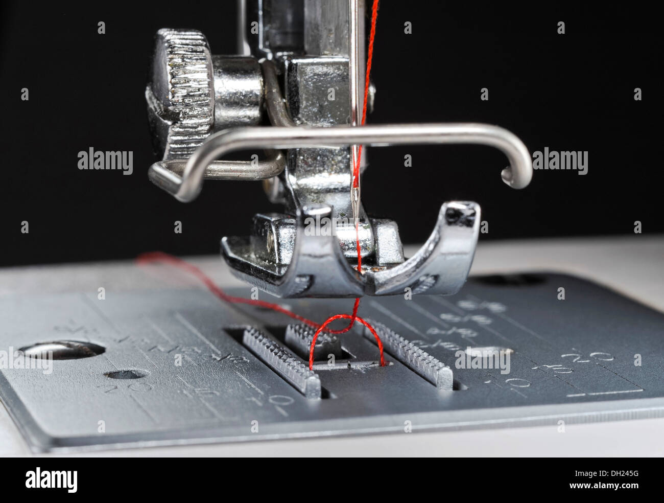 Sewing machine with presser foot and needle plate, upper thread and