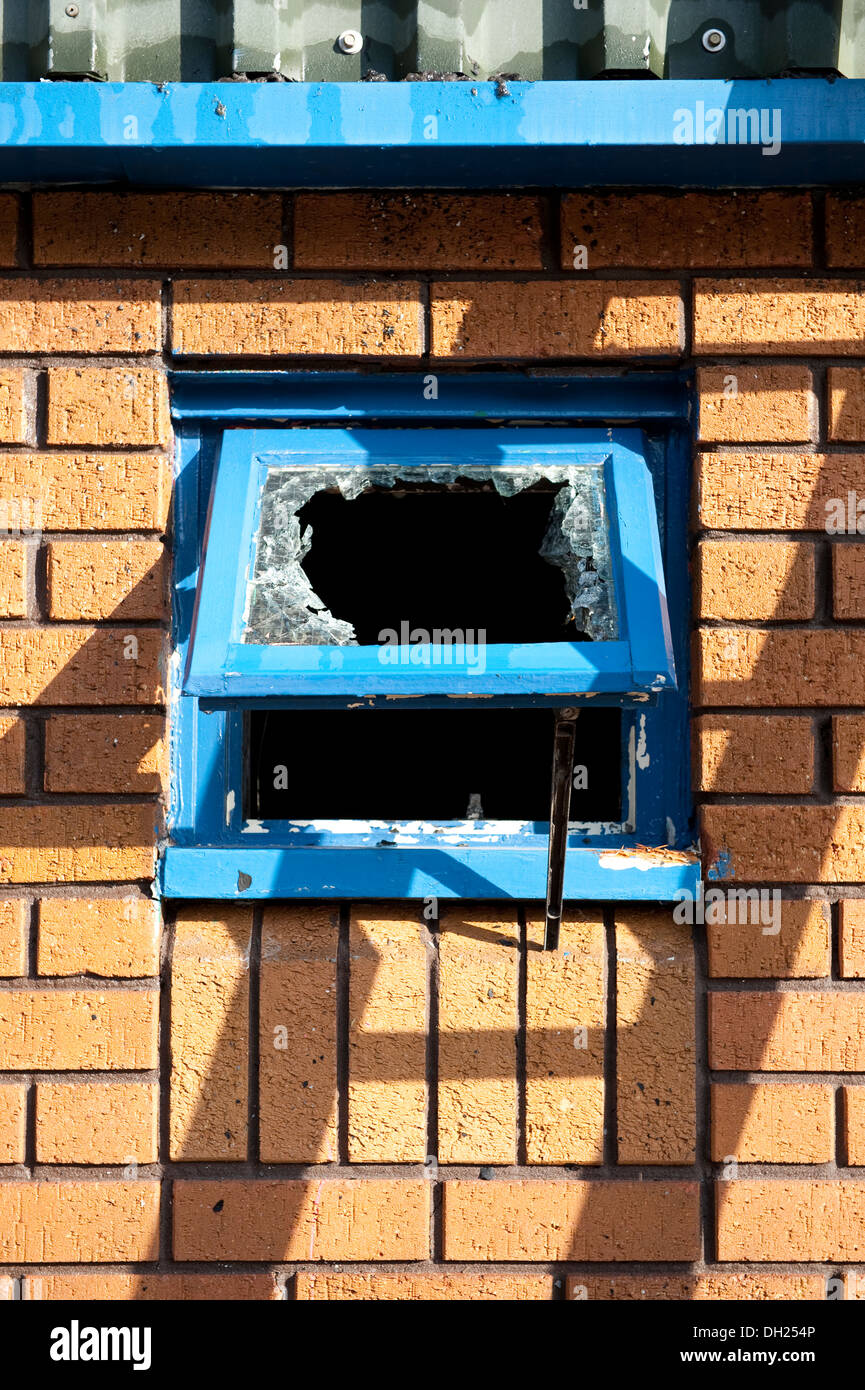 Smashed broken window break in theft burglary Stock Photo