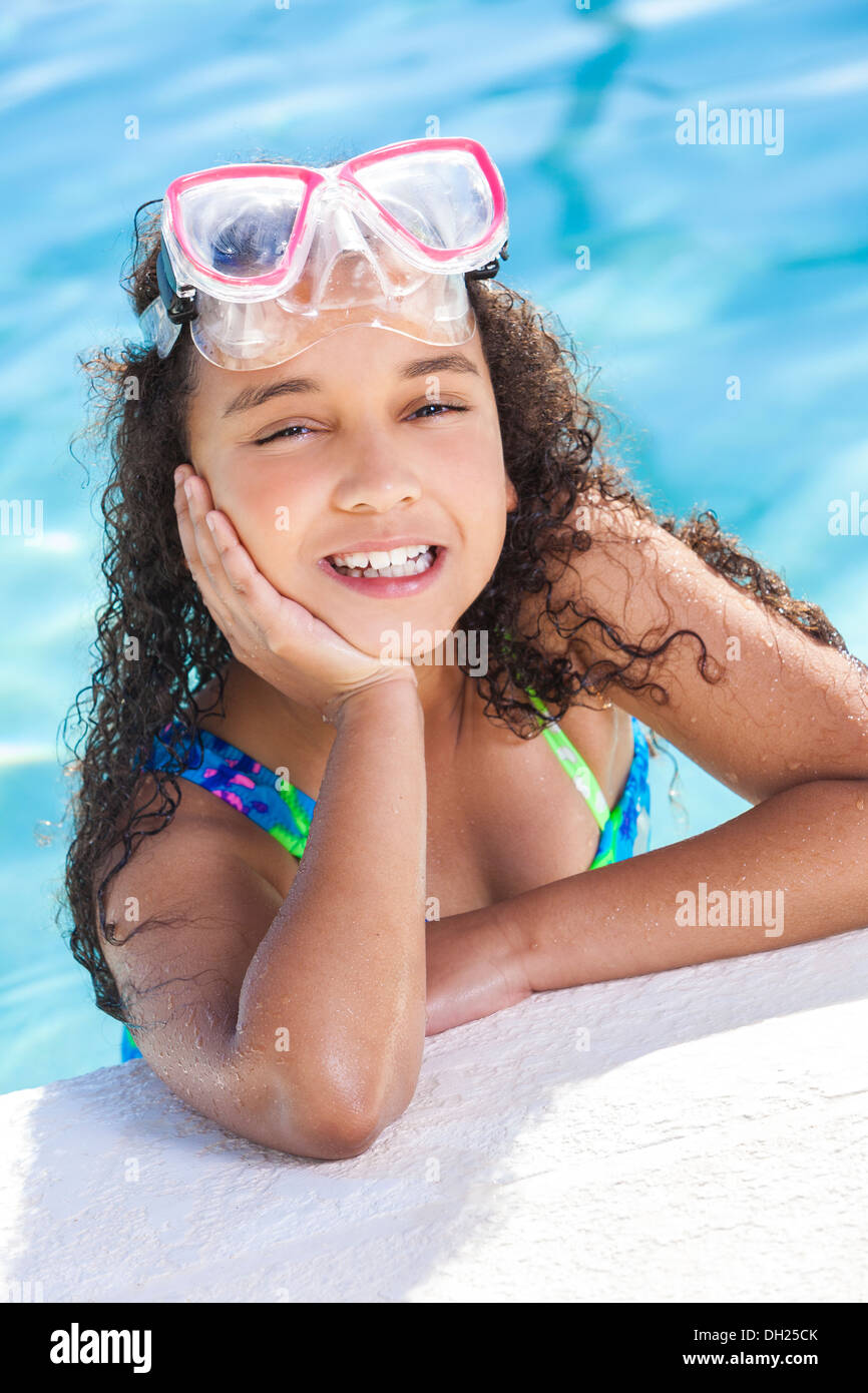 cute happy young interracial African American girl child relaxing on