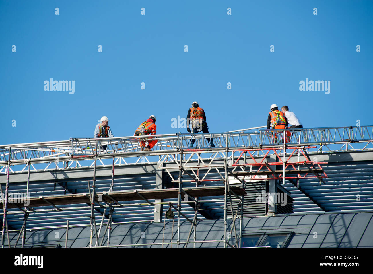 Roofers working on Scaffolding safety Harness H&S Stock Photo