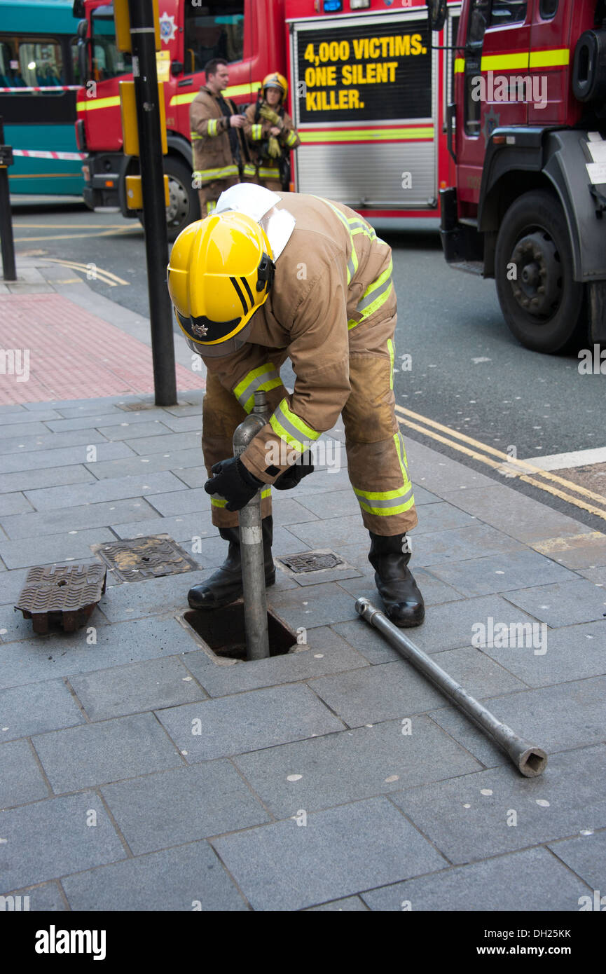 Firefighter setting in to a hydrant standpipe water supply Stock Photo