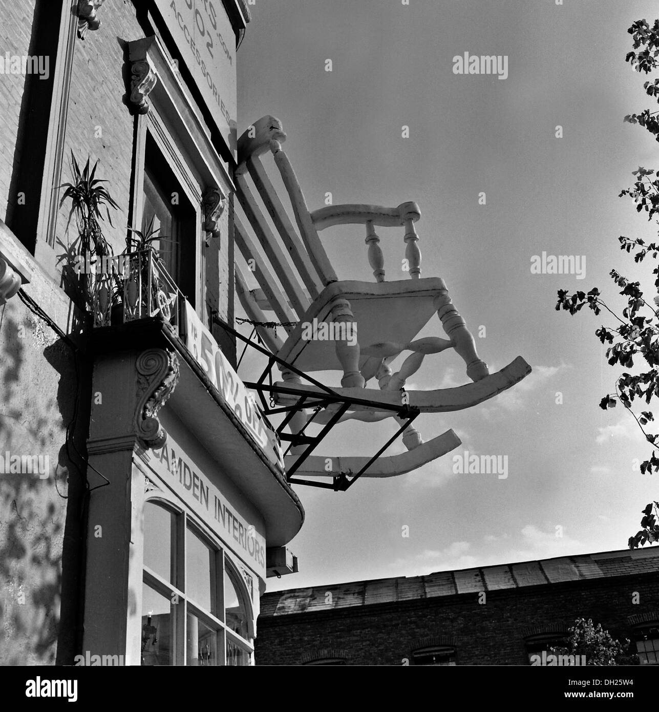 Over sized rocking chair attached to shop front Camden interiors Stock Photo