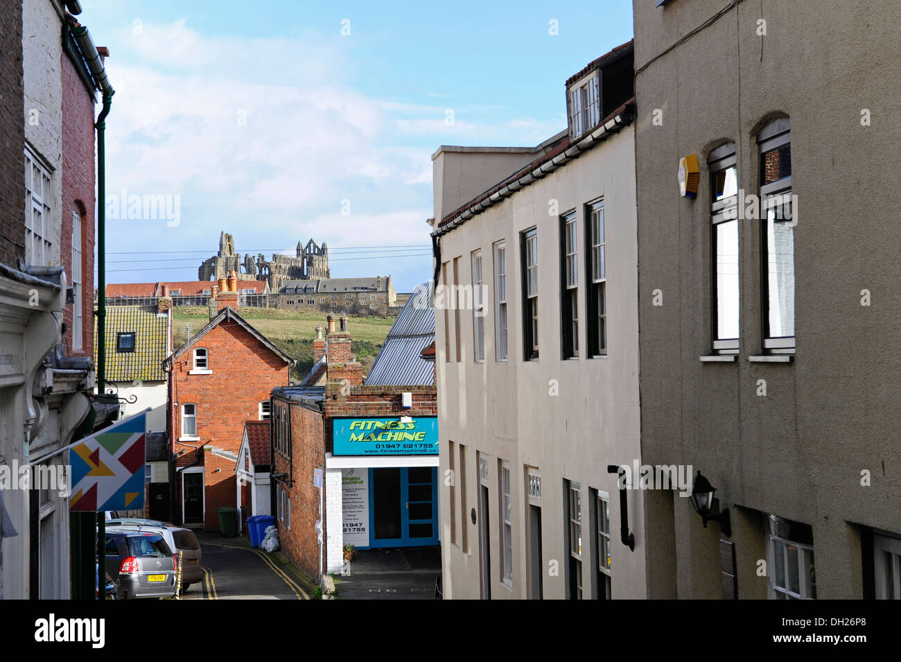 Side street in the fishing town of Whitby, North Yorkshire with the abbey in the background. Stock Photo