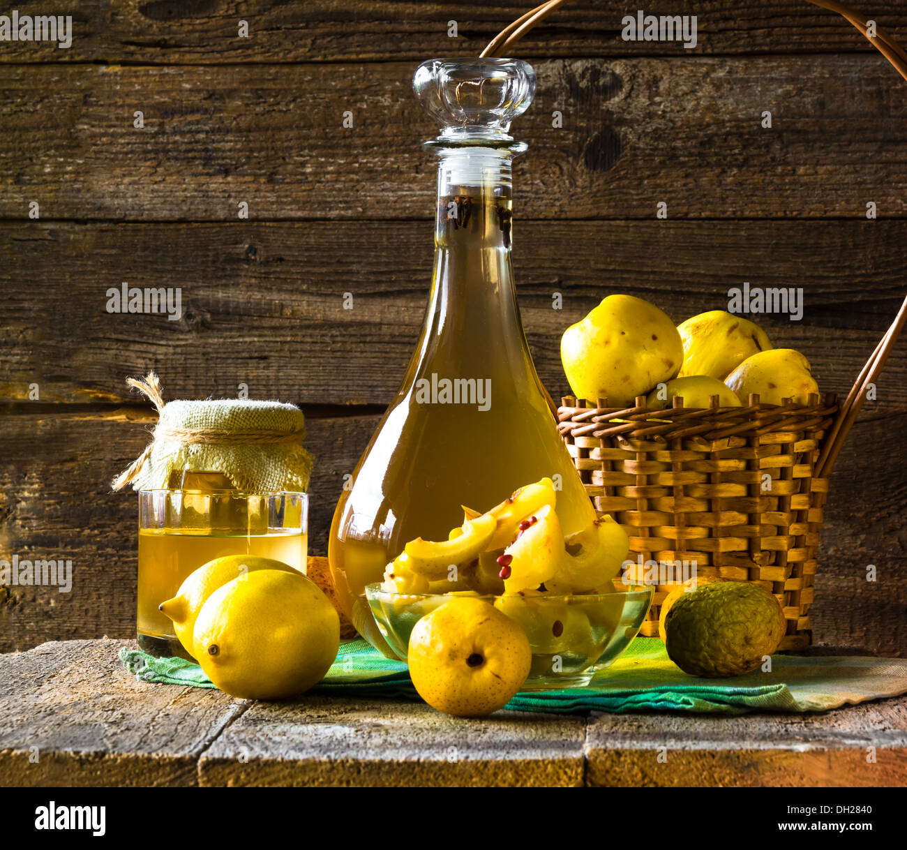 Tincture of quince and fruit on a wooden table Stock Photo