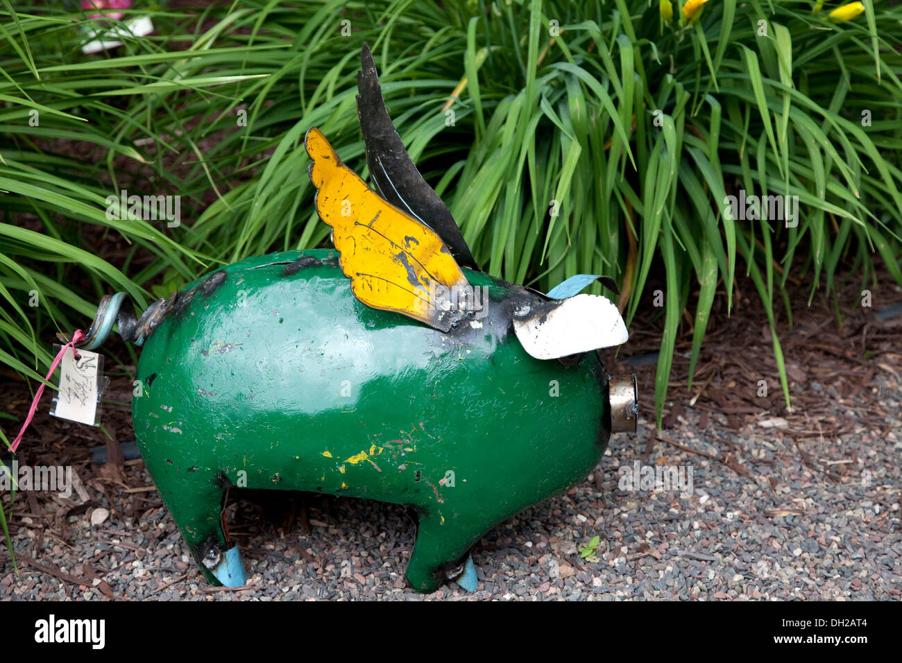 Artistic rendition of a small pig painted green in front yard. Cable Wisconsin WI USA Stock Photo