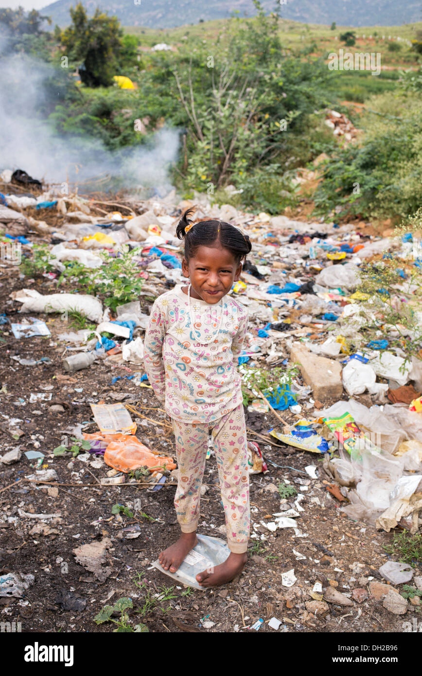 Poor Indian lower caste girl standing in a rubbish tip. Andhra Pradesh, India Stock Photo