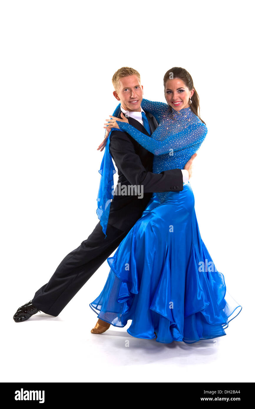 Young ballroom dancers in formal costumes posing against a solid background in a studio Stock Photo