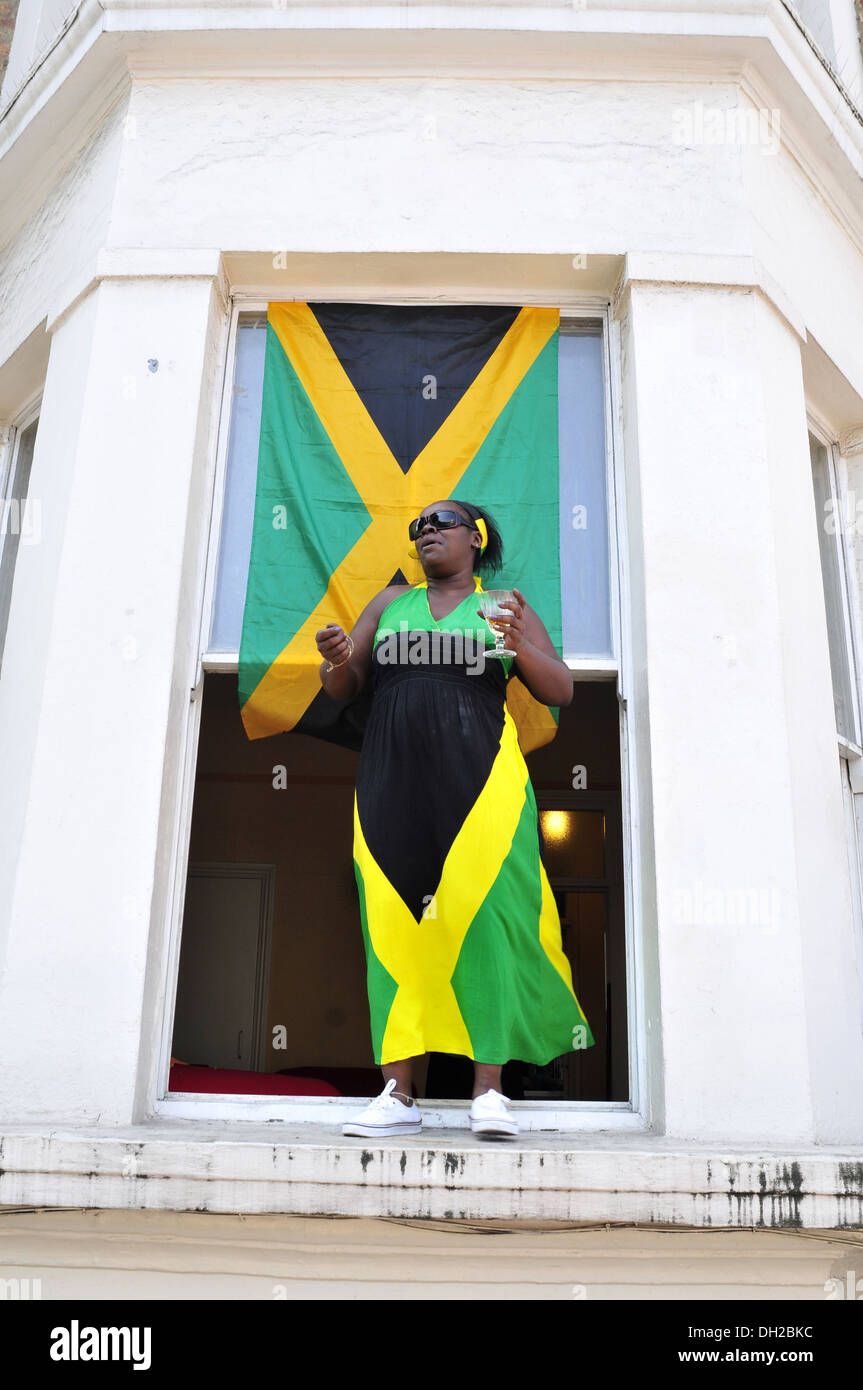 A woman wearing a Jamaican flag dress at the Notting Hill Carnival, London Stock Photo