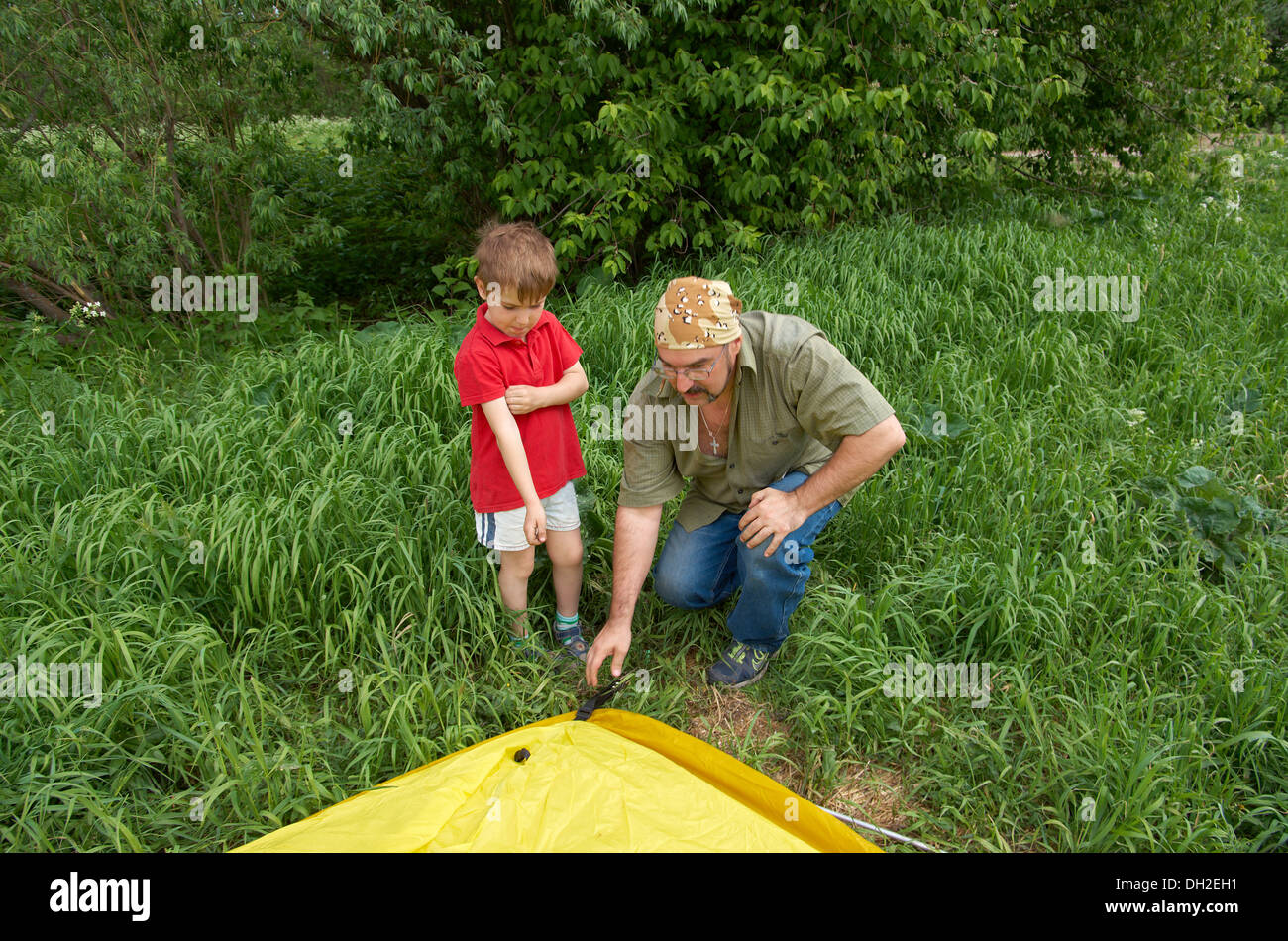 Father with children installing their tent Stock Photo