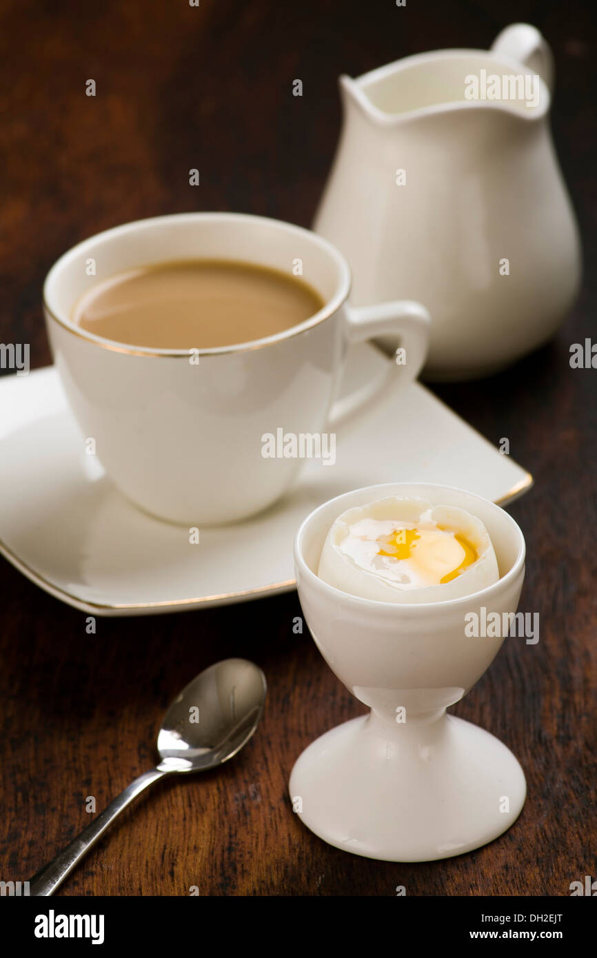 coffee with milk and boiled egg in eggcup Stock Photo