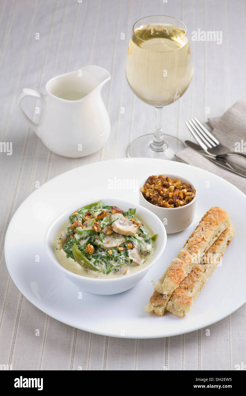 Mushrooms with spinach and green vegetables, served with nut crumble, and flatbread Stock Photo