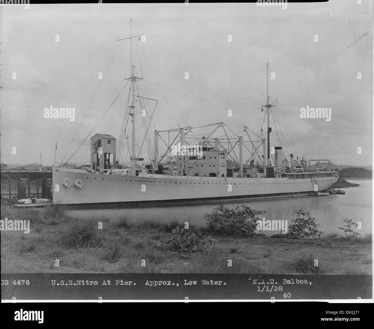 The Nitro (AE2) ammunition ship is docked at a wharf in this photograph ...