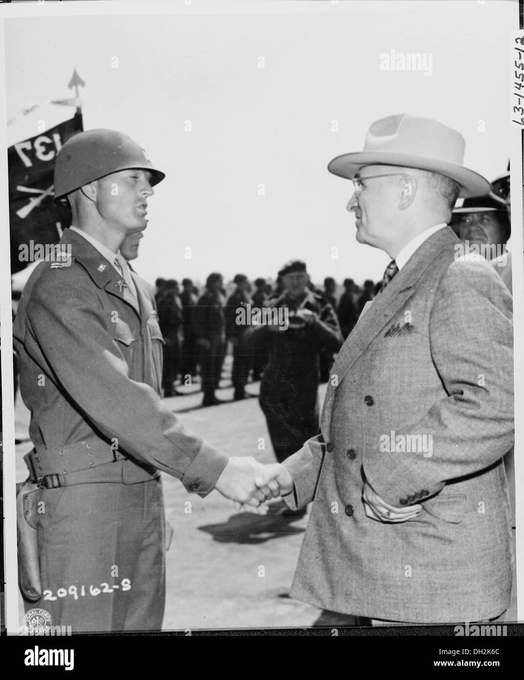 President Harry S. Truman meets Captain Clyde R. Mills, a member of the 137th Infantry, 35th Division, at an airfield... 198787 Stock Photo