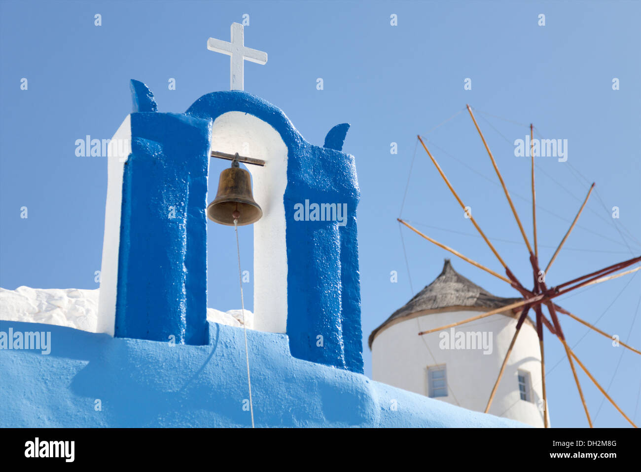 windmill and a cross with a bell, Santorini Stock Photo