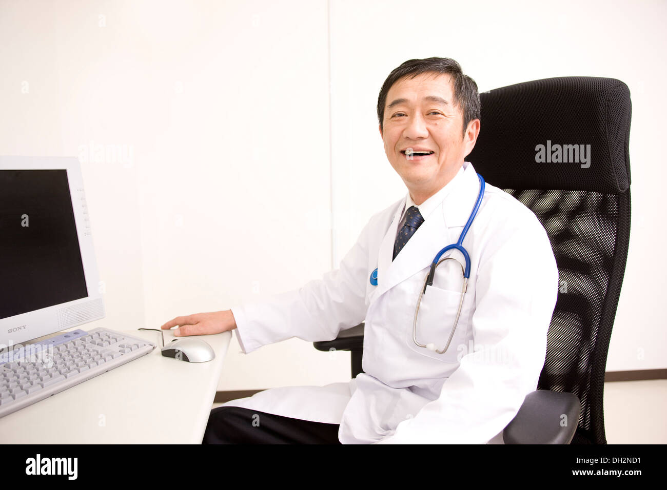 Male doctor sitting on chair hi-res stock photography and images - Alamy