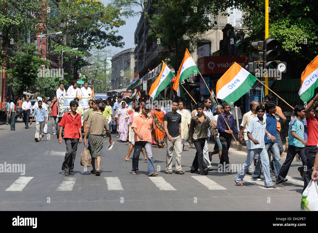men holding flags of TMC political party rally in Central Kolkata west bengal India Asia Stock Photo