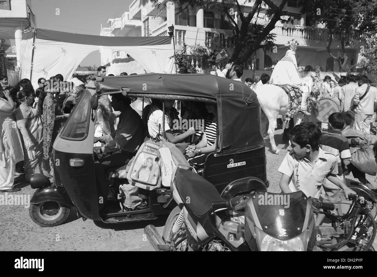 Auto Rickshaw and wedding procession on the street of Jabalpur Madhya Pradesh India Asia Stock Photo