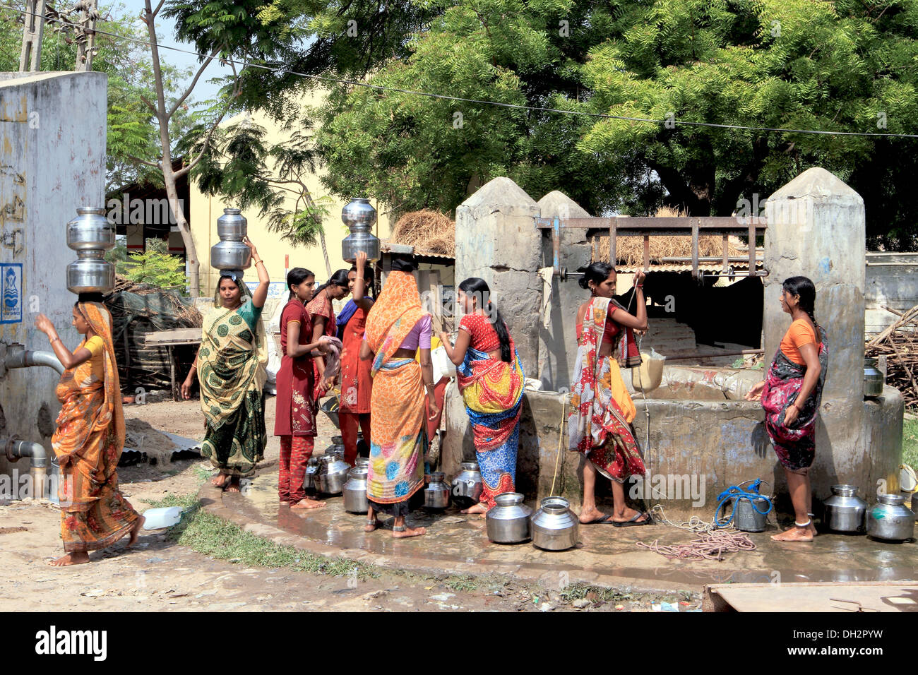 Women at village well collecting drinking water Bharuch Gujrat India Asia Stock Photo