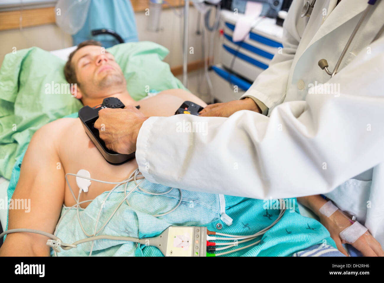 Doctor Defibrillating Patient In Emergency Stock Photo
