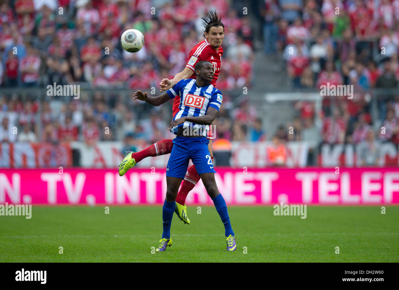 Munich, Germany. 26th Oct, 2013. Munich's Daniel van Buyten (A) vies for the ball with Berlin's Adrian Ramos during the German Bundesliga match between FC Bayern Munich and Hertha BSC at Allianz Arena in Munich, Germany, 26 October 2013. Photo: THOMAS EISENHUTH/dpa/Alamy Live News Stock Photo