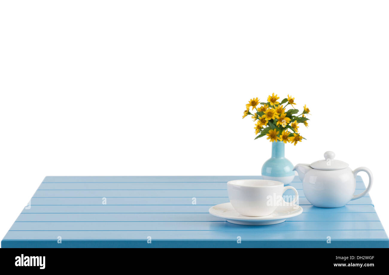 A porcelain cup and teapot on the wooden table with empty space Stock Photo
