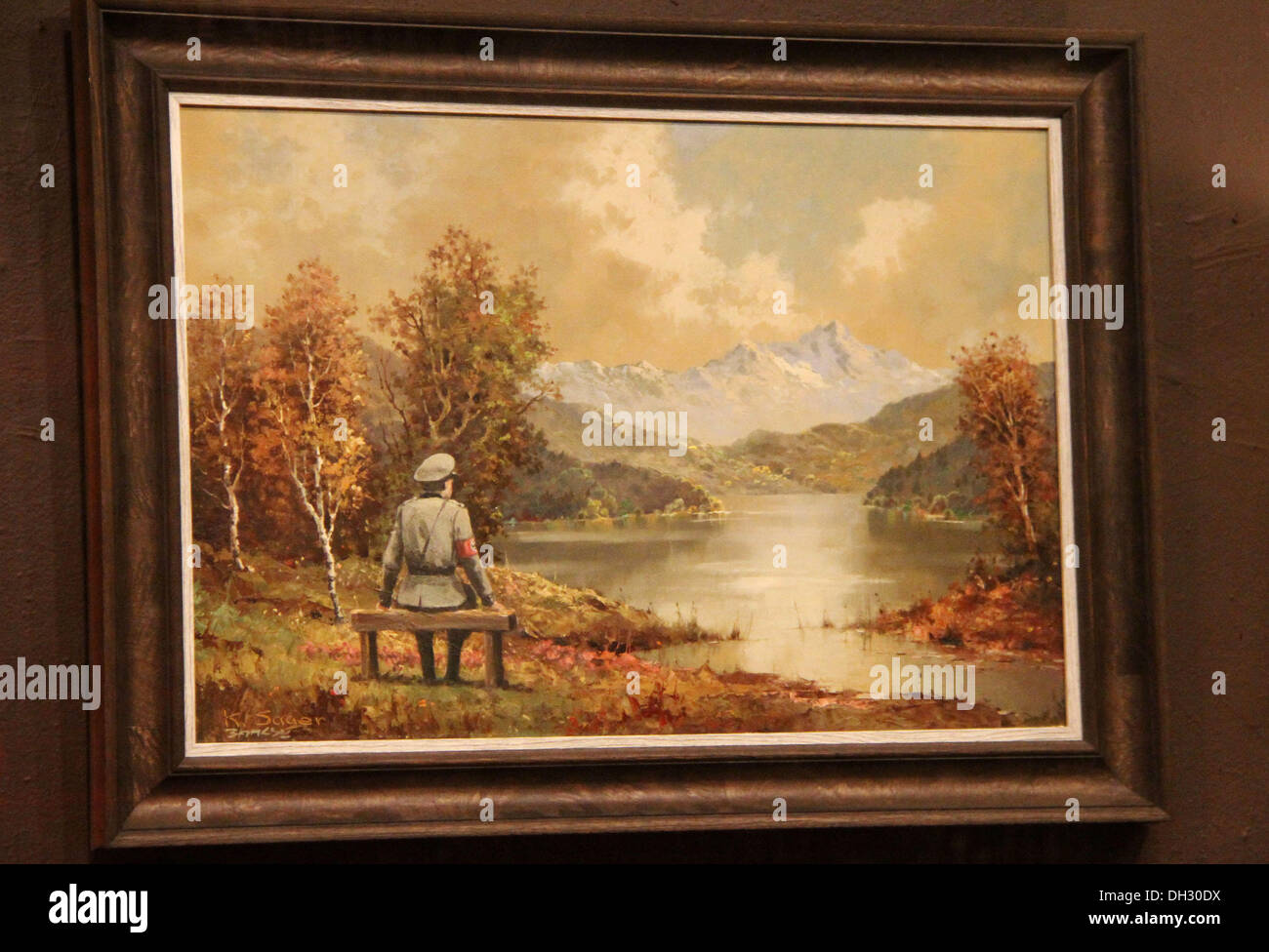 New York, New York, USA. 29th Oct, 2013. A view of the 'vandalized' Nazi soldier painting entitled 'The banality of the banality of evil' by British artist Banksy's, located at the Housing Works Gramercy thrift shop. The painting was a thrift store painting by K.Sager which Banksy is believed to have purchased and added or 'vandalized' the Nazi soldier sitting on a bench. Banksy also added his signature below the original artist. It was then returned to the thrift store where it will be auctioned to benefit HIV/AIDS and homelessness needs on Friday. © ZUMA Press, Inc./Alamy Live News Stock Photo