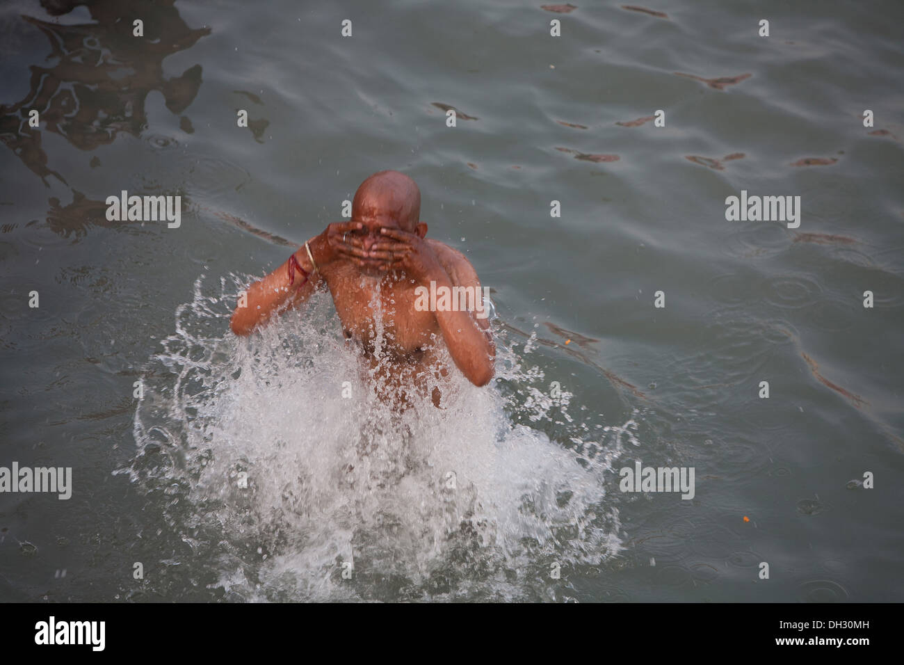man taking holy dip in Ganga river ganges at Haridwar Uttarakhand India Asia Stock Photo