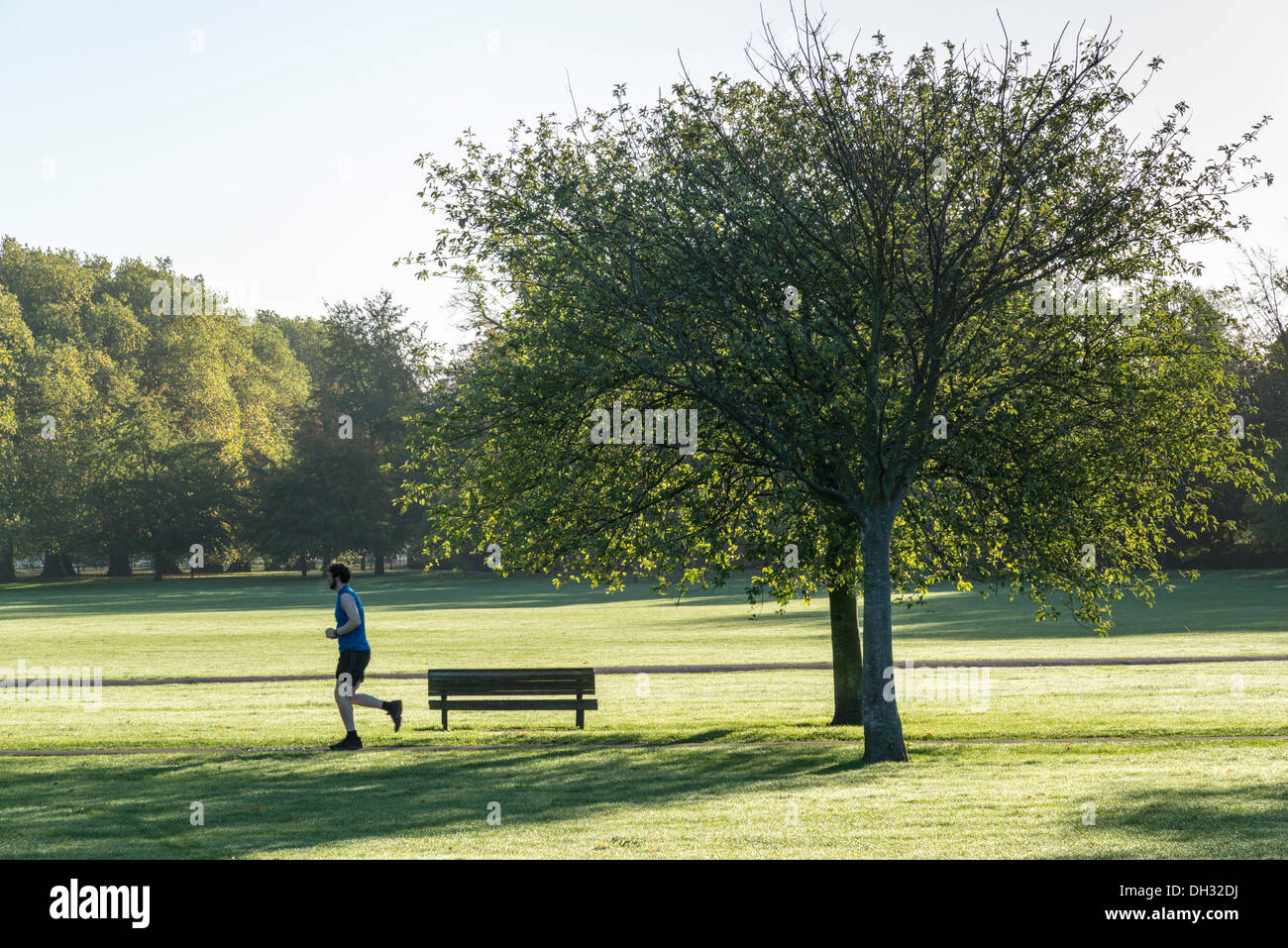 Cambridge, UK. 30th Oct, 2013. A man jogs in early morning light across Jesus Green Cambridge UK 30th October 2013. After a cold night with one of the first frosts of the year Cambridge basks in glorious autumn sunshine. Credit Julian Eales/ Alamy Live News Stock Photo