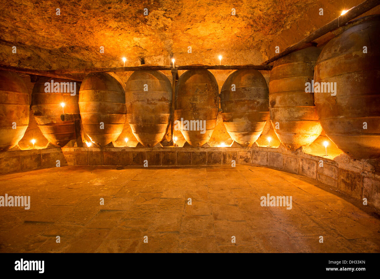 Antique winery in Spain with clay vessels terracotta amphora pots Mediterranean tradition with candlelight Stock Photo