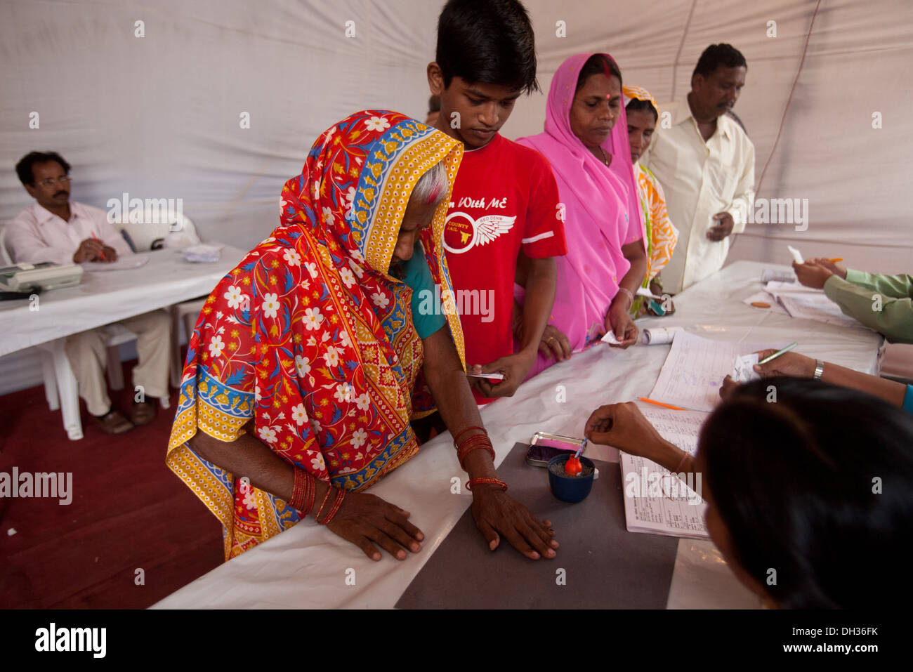 Indian election polling official marking finger with indelible ink for voting Mumbai Maharashtra India Asia Stock Photo