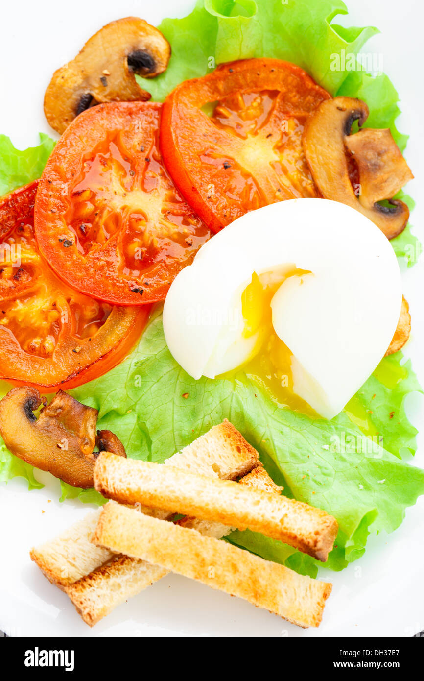 Light breakfast with soft egg, tomato and croutons Stock Photo