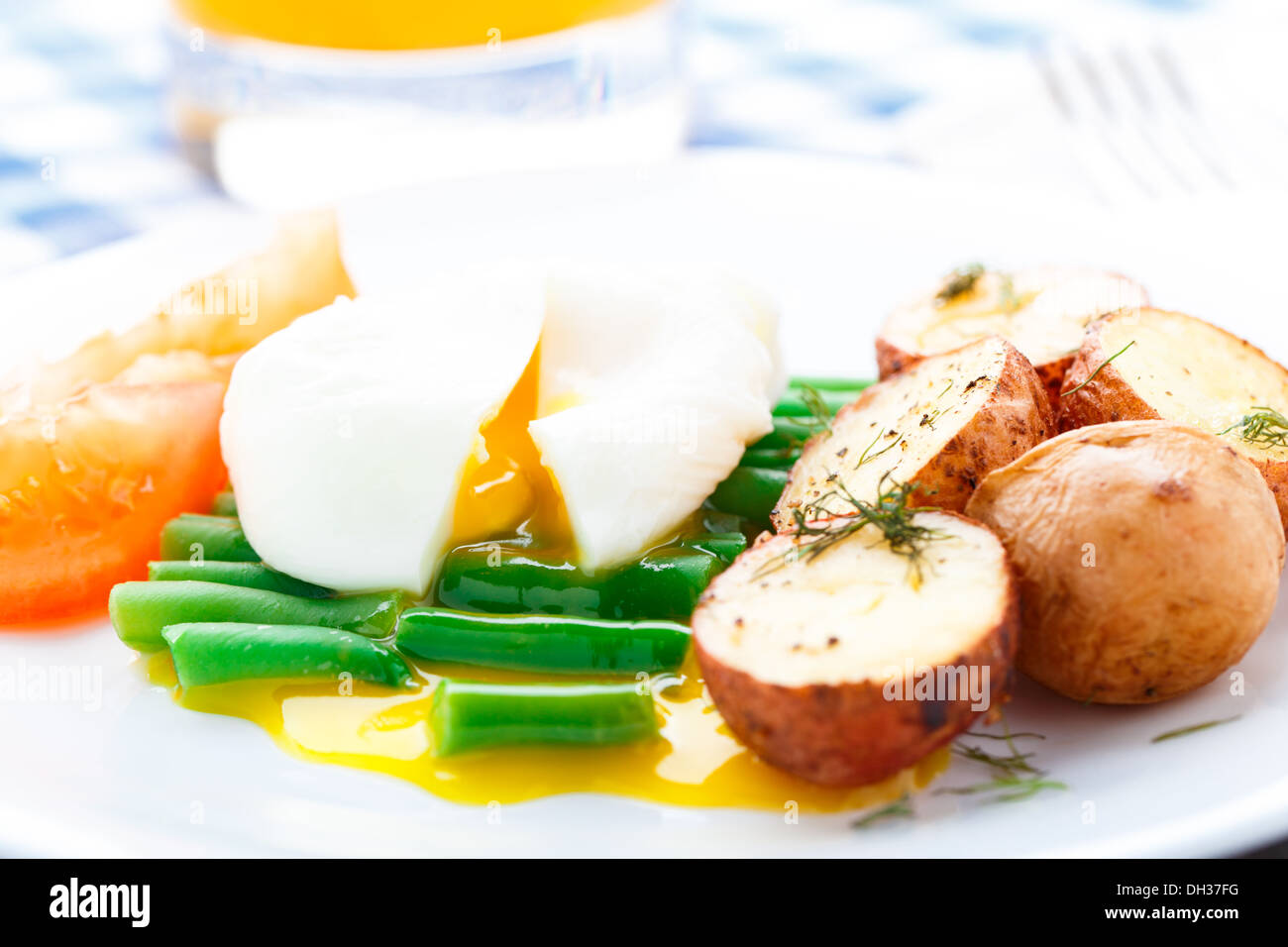 Poached egg with french beans and baked potato Stock Photo Alamy