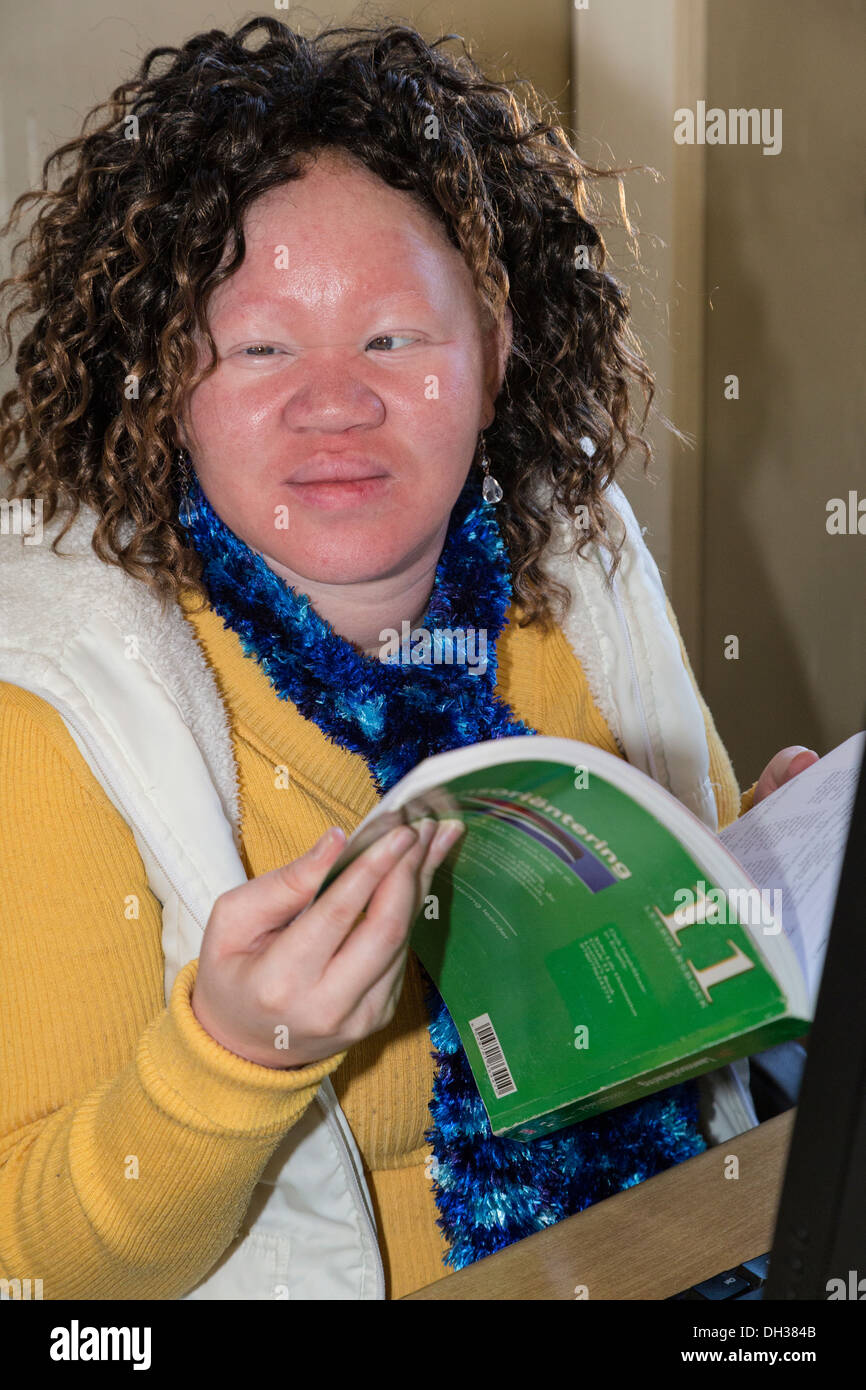 South Africa, Cape Town. Visually-impaired Albino Student Holding Student Workbook. Athlone School for the Blind. Stock Photo
