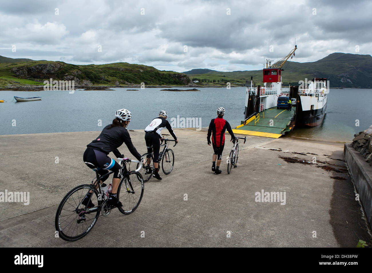 Three cyclists prepare to board a ferry in the Scottish Highlands, Scotland, United Kingdom Stock Photo