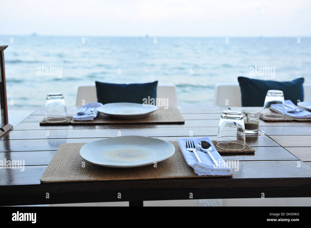 Dining table prepared close to the sea Stock Photo