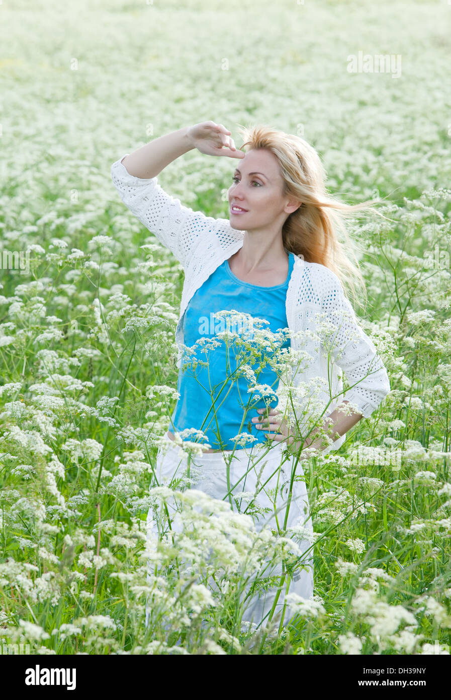 woman in the field of white wild flowers Stock Photo